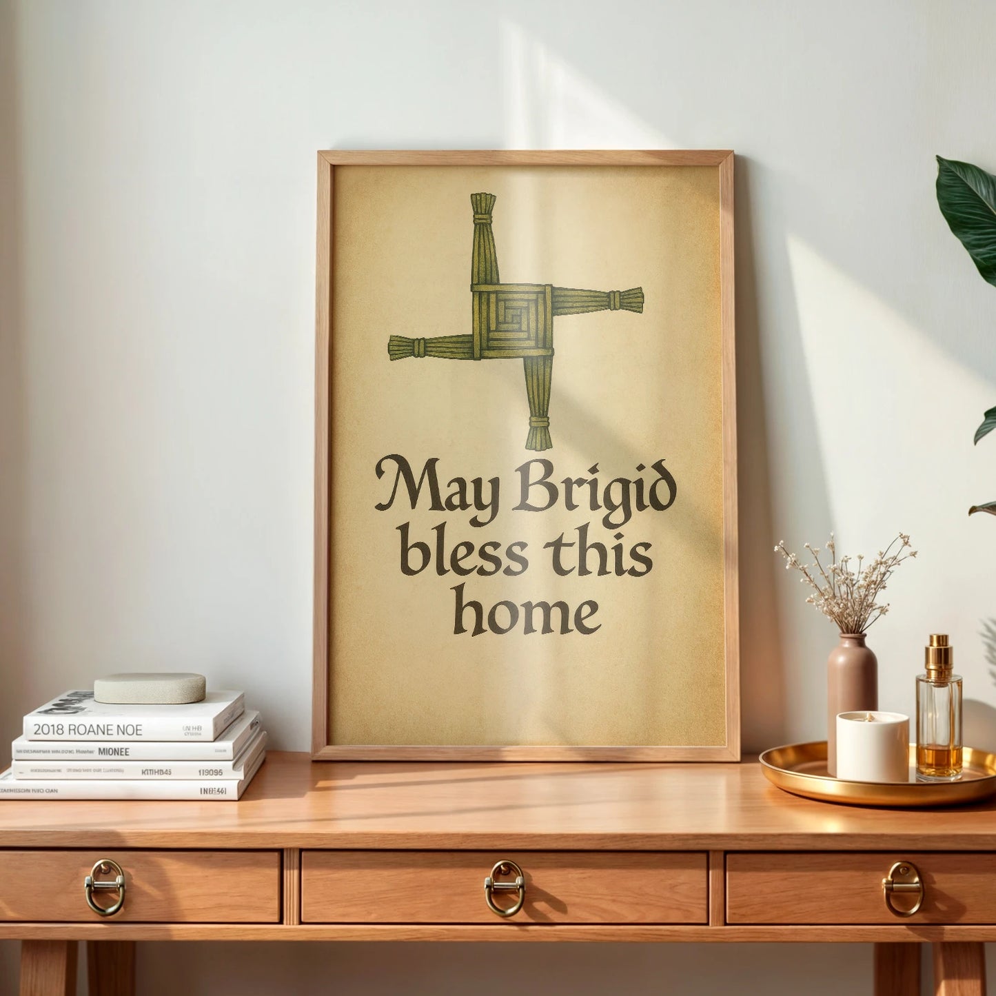 Natural wood desk with framed Brigid’s Cross Blessing print, styled with Irish home decor books and warm morning light.