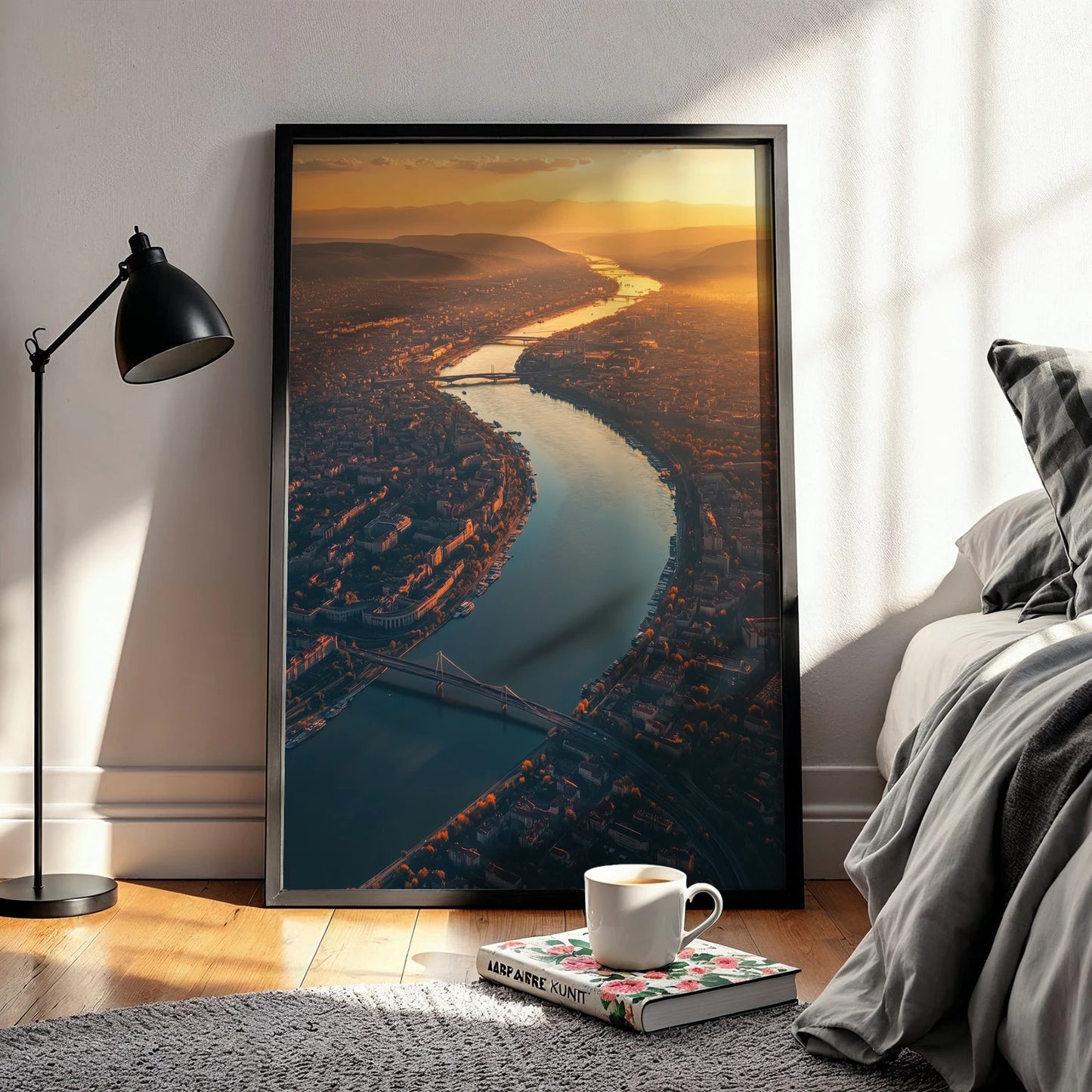 Framed Budapest sunset travel wall art leaning against a bedroom wall