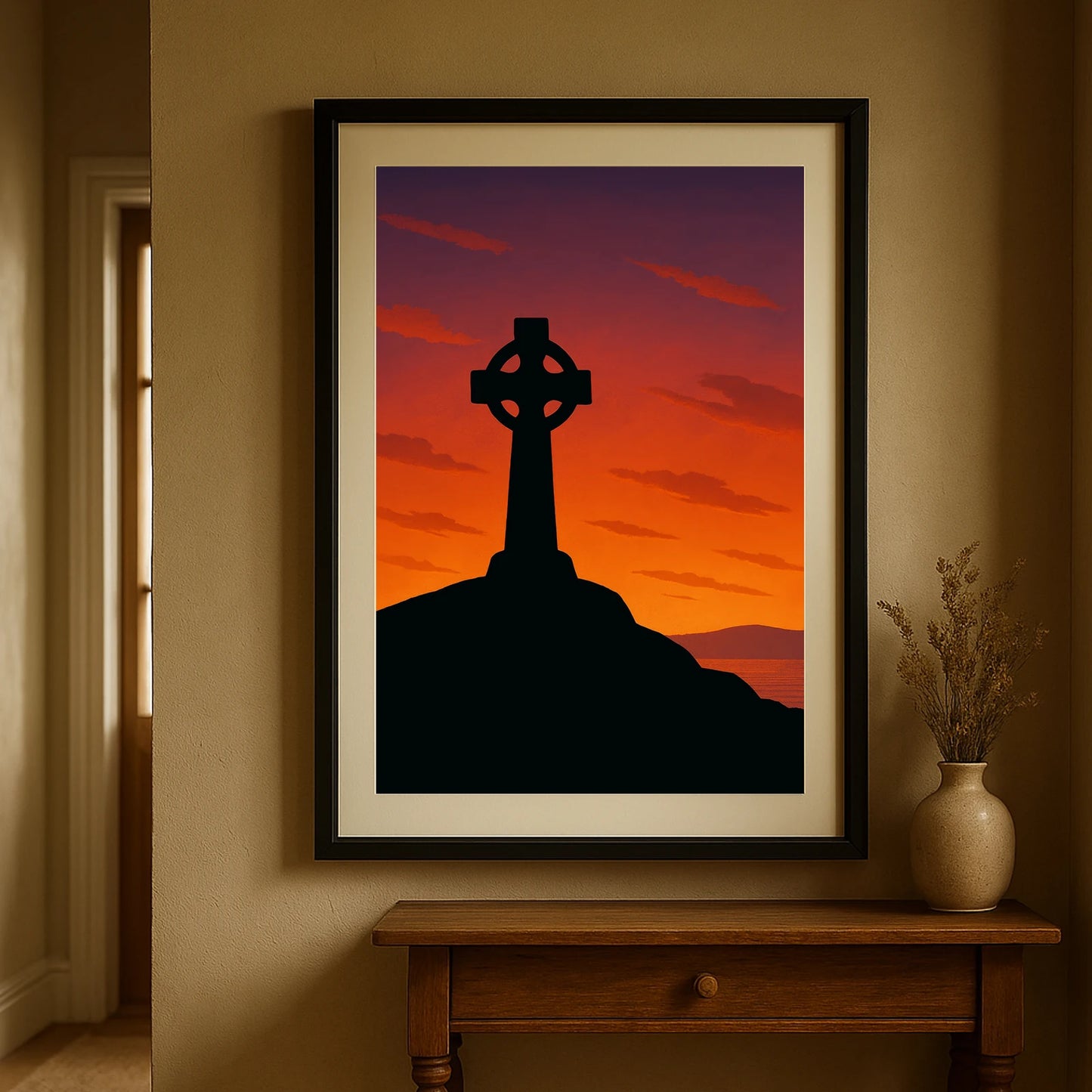 Black frame version of Celtic Cross at Sunset print hanging in a hallway with beige walls – rooted in Celtic mythology