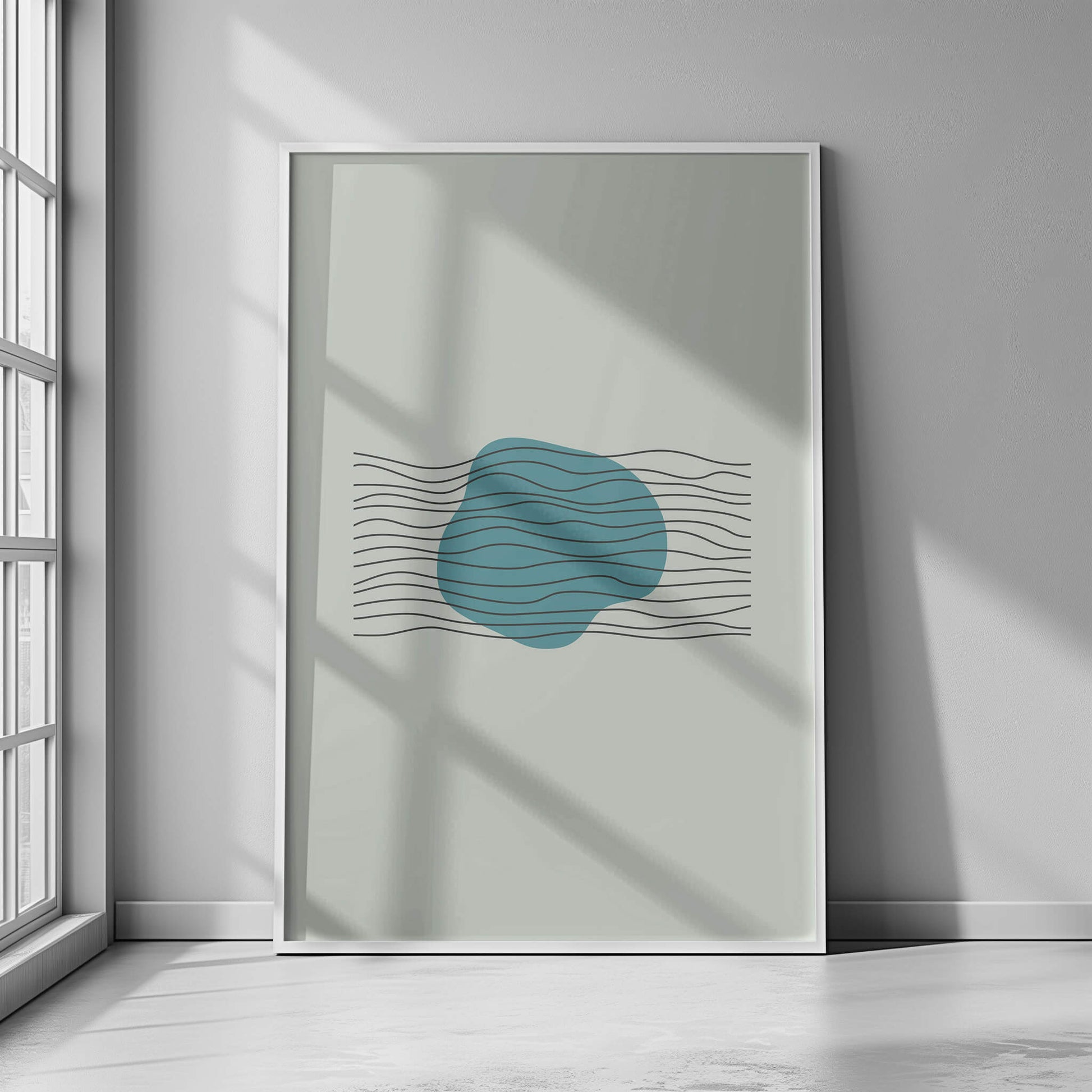 Aqua Harmony Print in a white frame, displayed in natural light with teal abstract design and soft black waves.