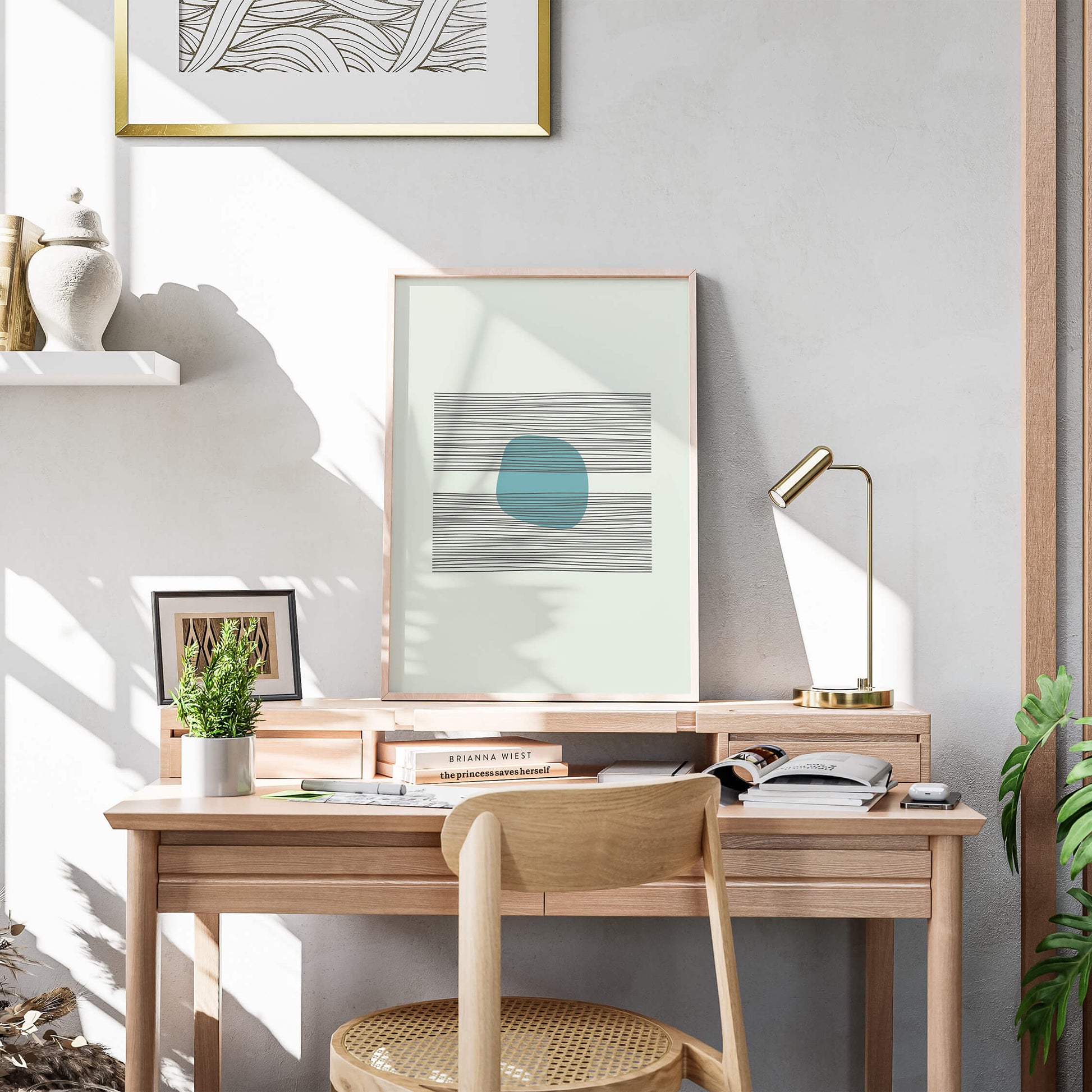 Azure Balance Print in a light wood frame, standing on a wooden desk surrounded by indoor plants and books.