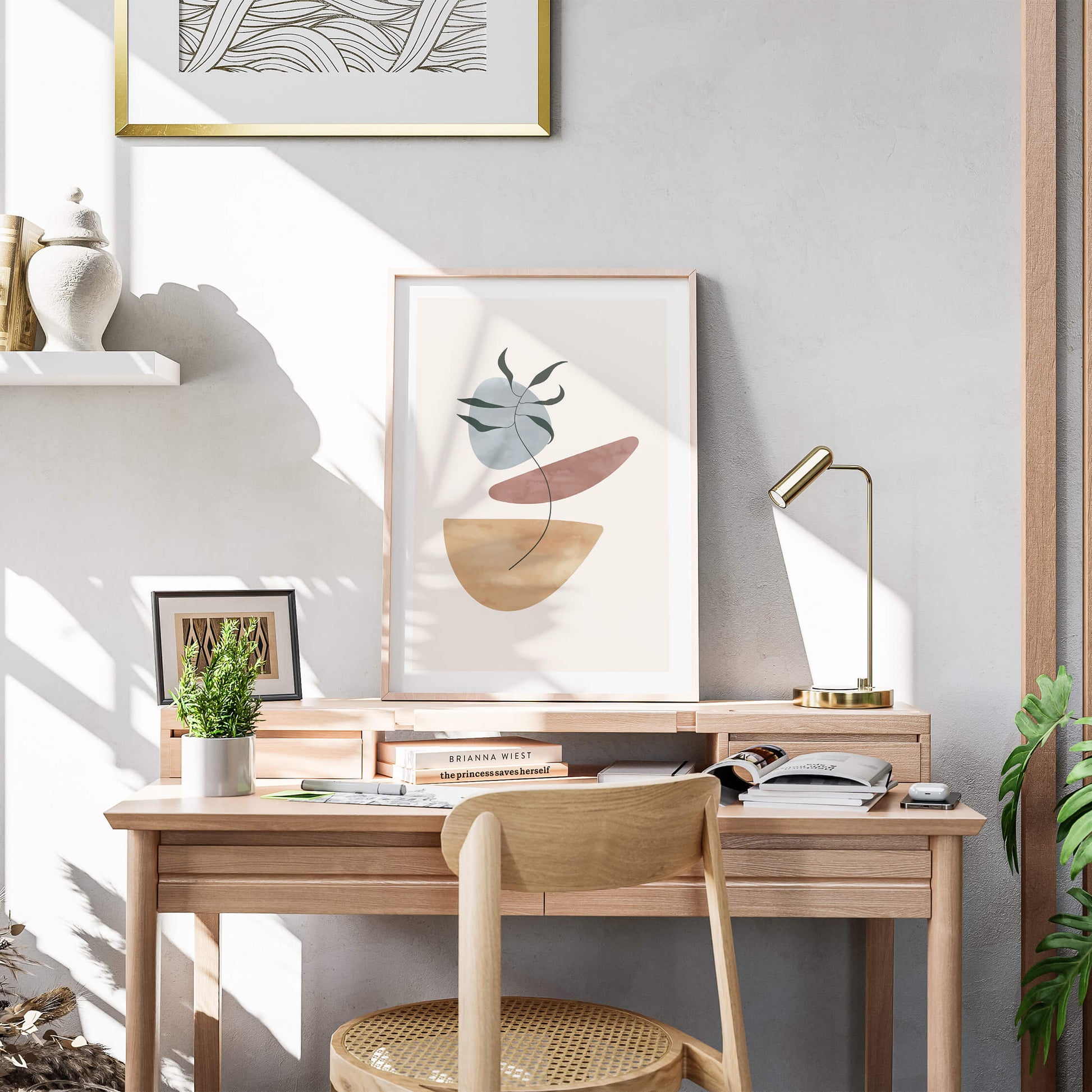 Elegant palm abstract print on a wooden desk with decor accents and sunlight streaming in.
