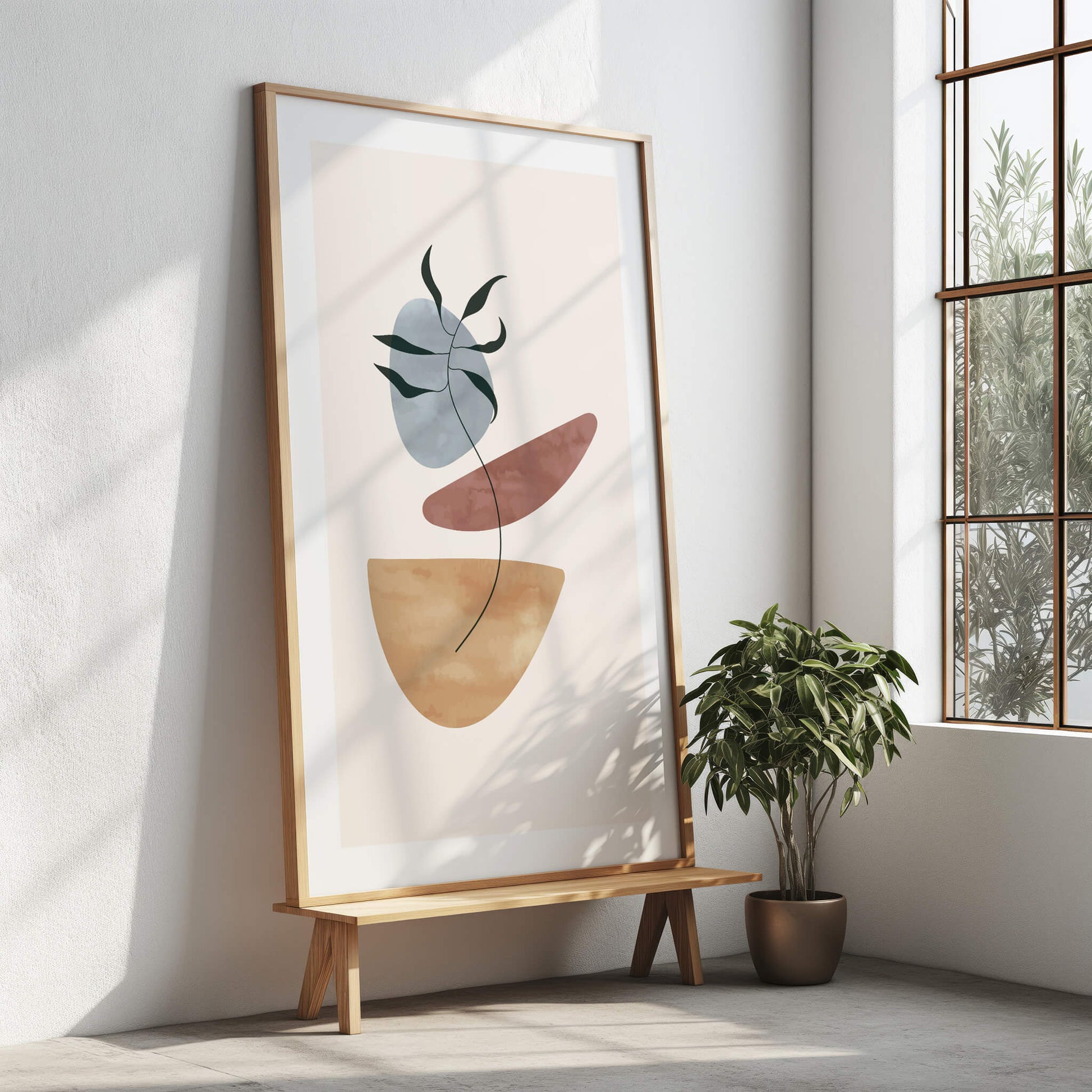 Palm print in a large wooden frame standing on a modern bench in a sunlit room.
