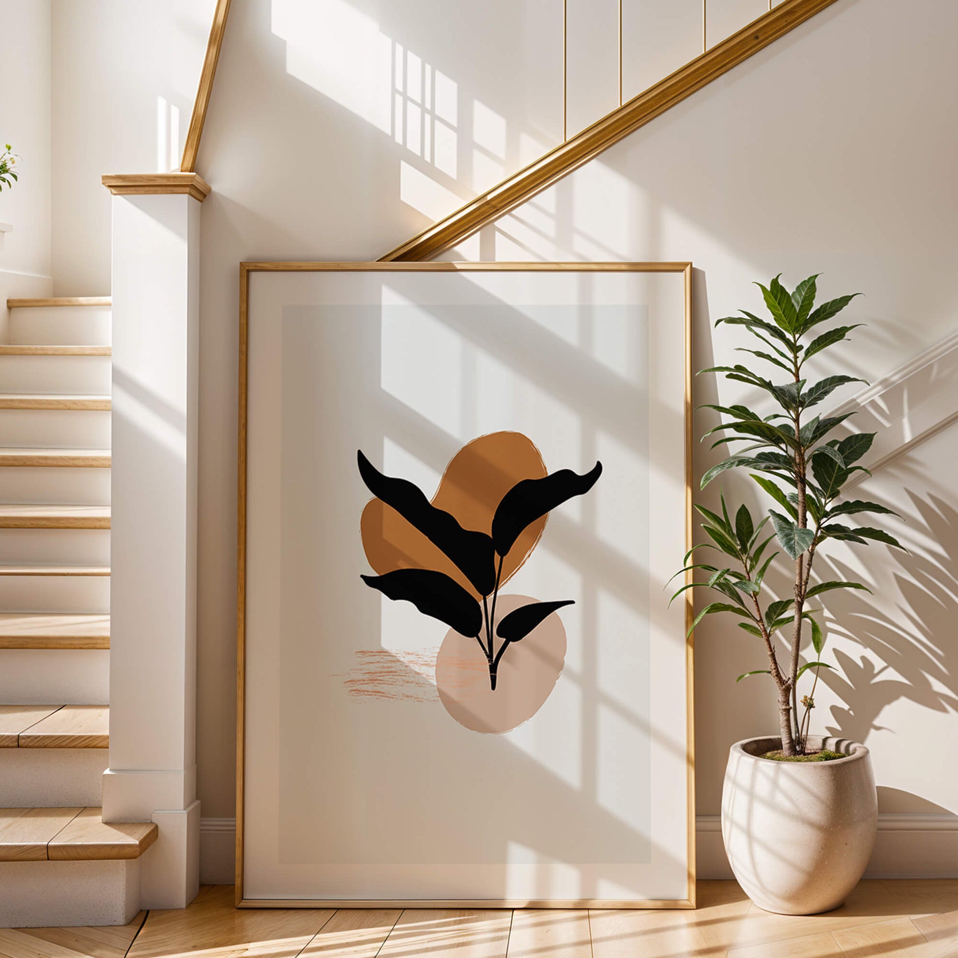 Black leaf abstract art framed and styled beside a staircase with natural light casting shadows.
