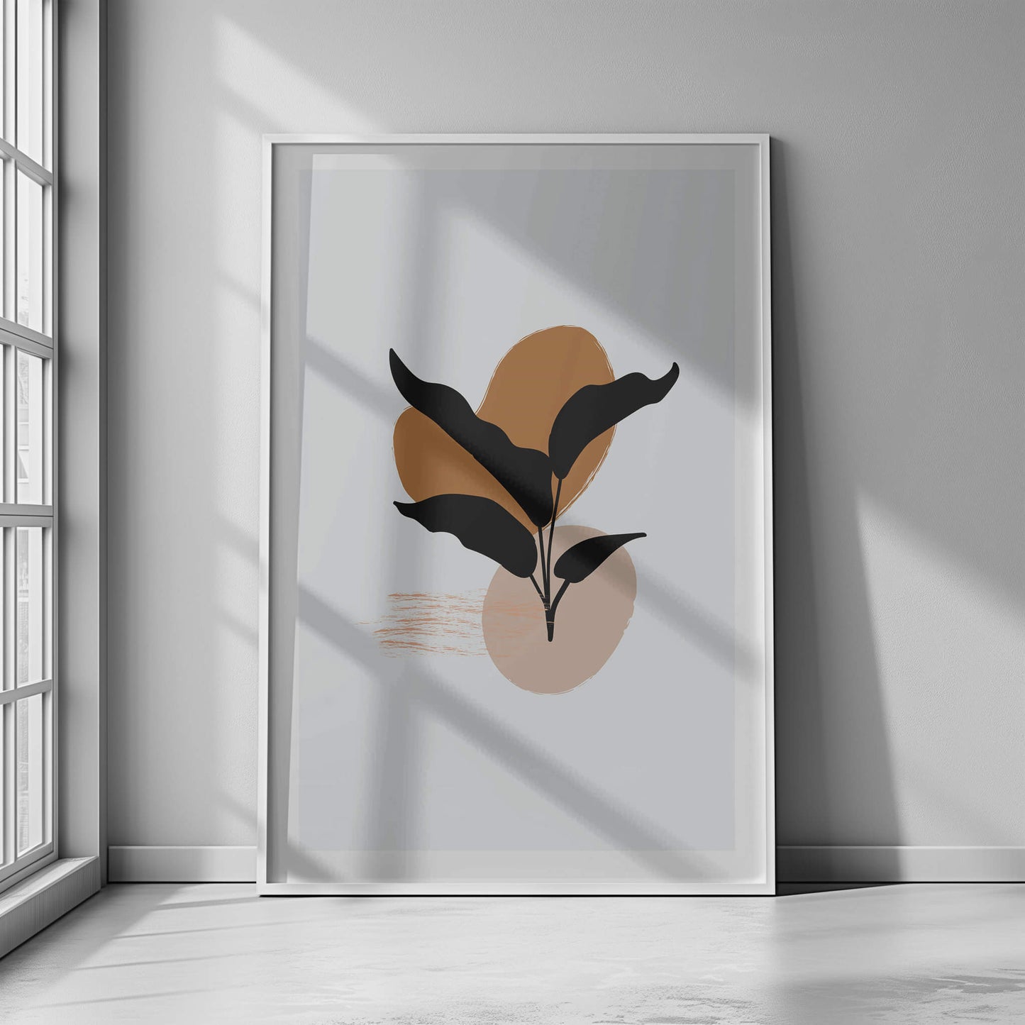 White-framed black leaf abstract print showcased under natural light, adding a contemporary touch to the decor.
