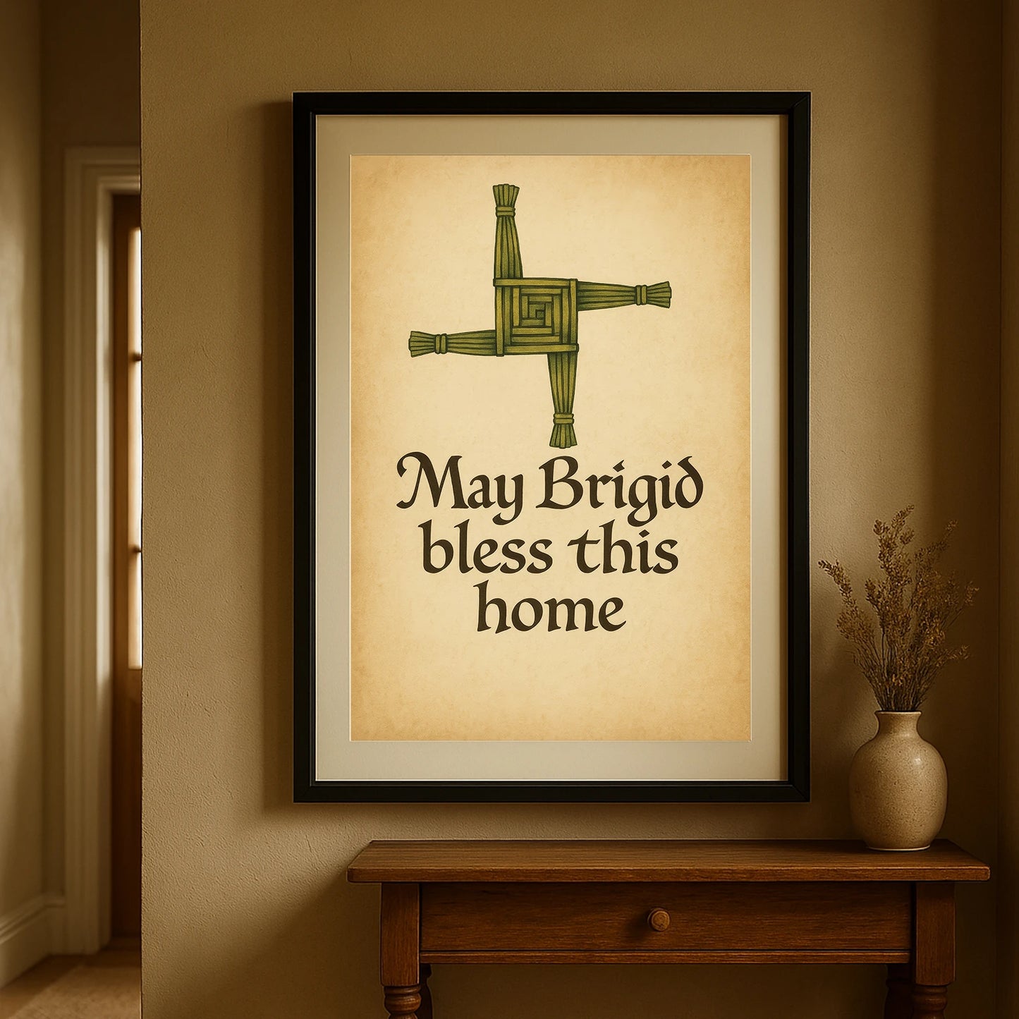 Hallway view of Brigid’s Cross Blessing art print in a black frame, styled on a rustic wooden table with dried flowers.