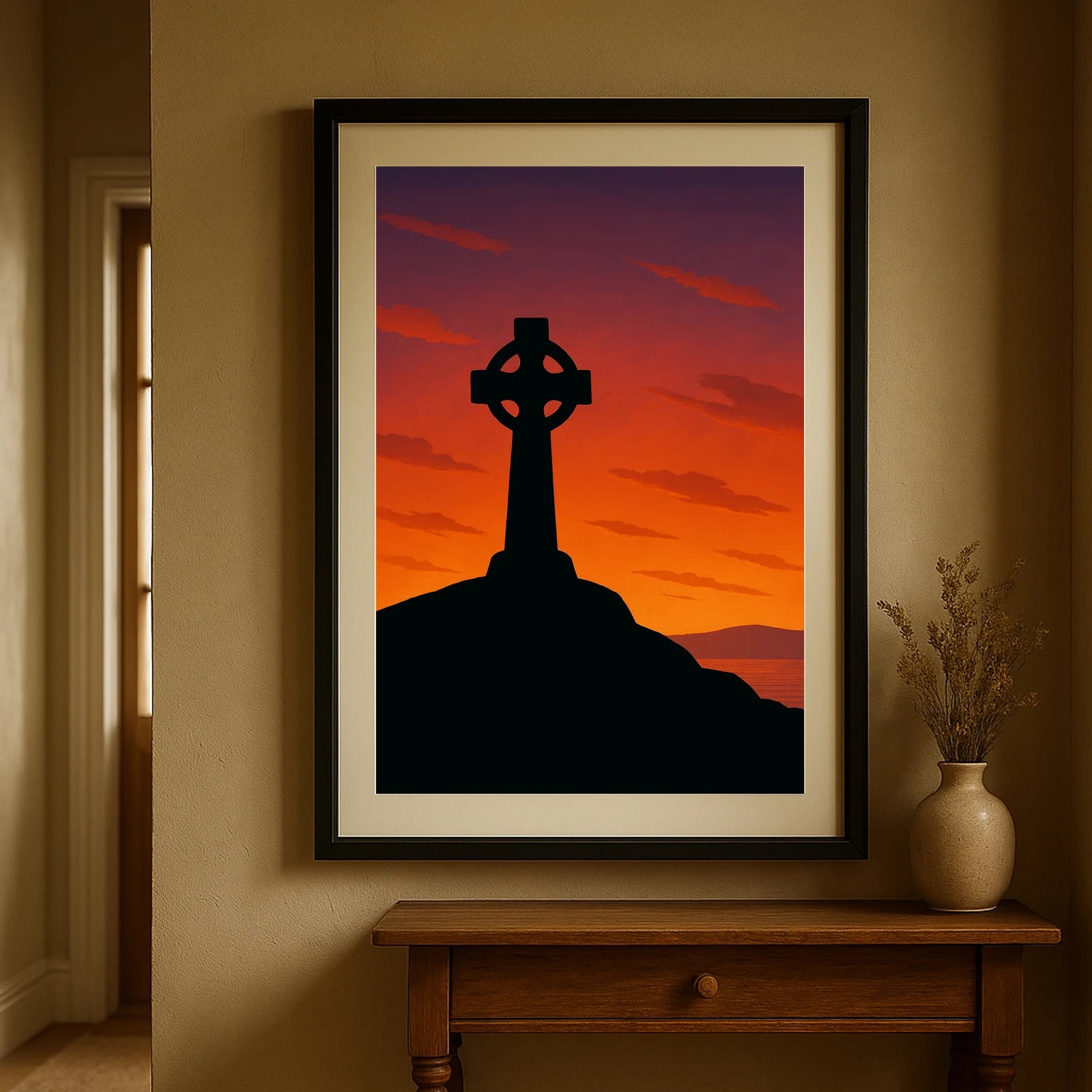 Black frame version of Celtic Cross at Sunset print hanging in a hallway with beige walls – rooted in Celtic mythology