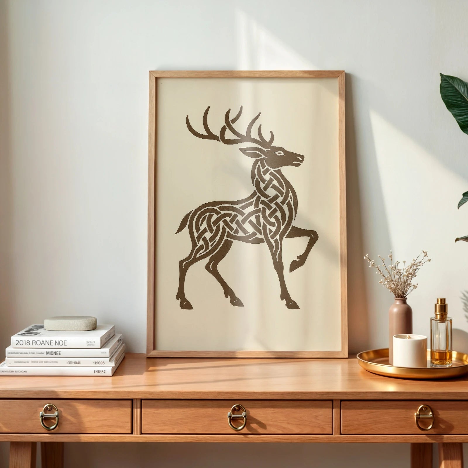 Wooden frame Celtic knotwork stag print on natural wood desk, styled with books and tray decor – inspired by Irish mythology.