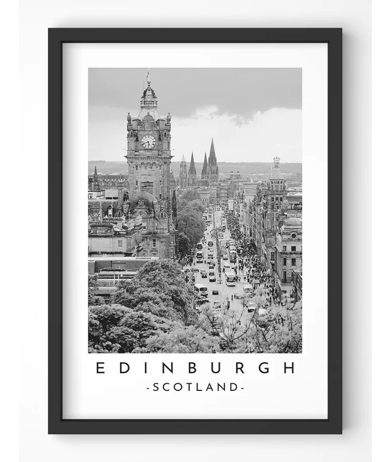 Black and white photograph of Princes Street in Edinburgh, Scotland, with Edinburgh Castle in the background.
