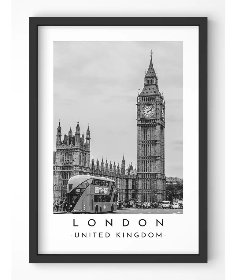 Black and white photograph of Big Ben and the Houses of Parliament in London, England, with a red double-decker bus in front.
