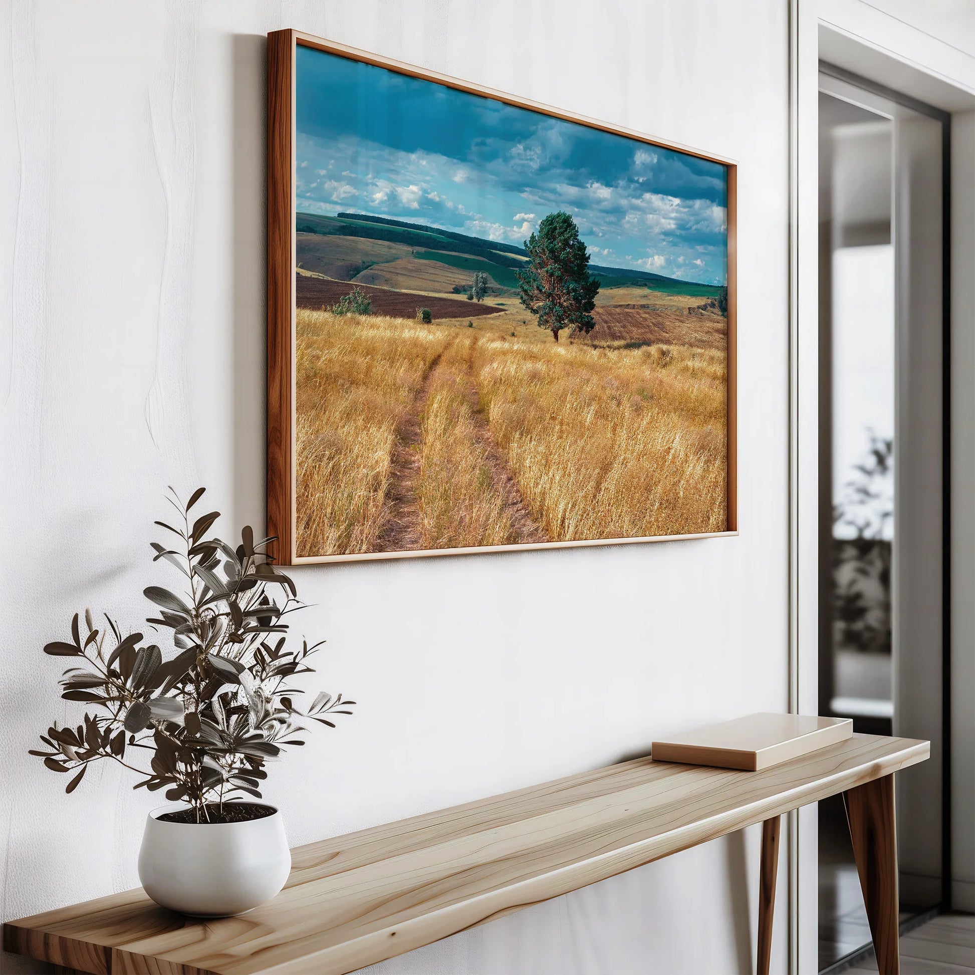 Nature-inspired wall art hanging on a minimalist white wall with wooden accents.
