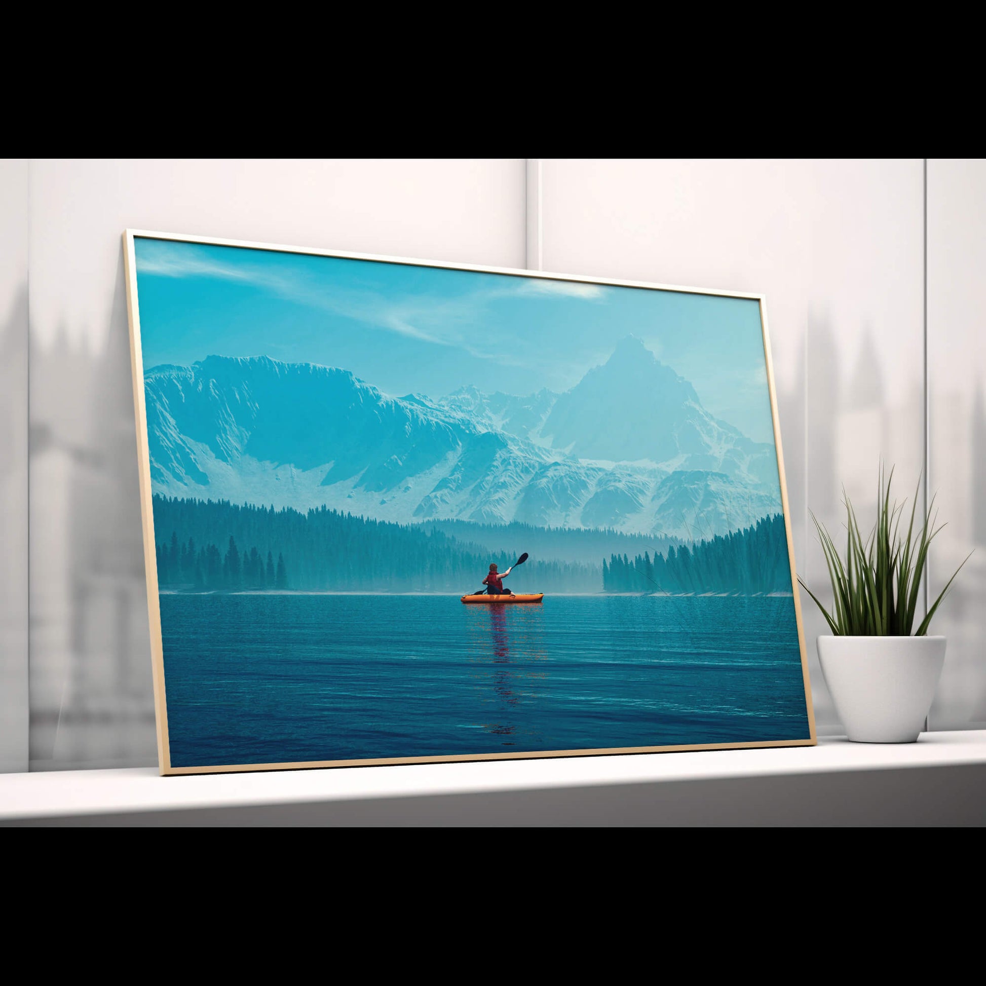 Framed landscape print of a kayaker on a misty lake, placed on a shelf beside minimalist decor.
