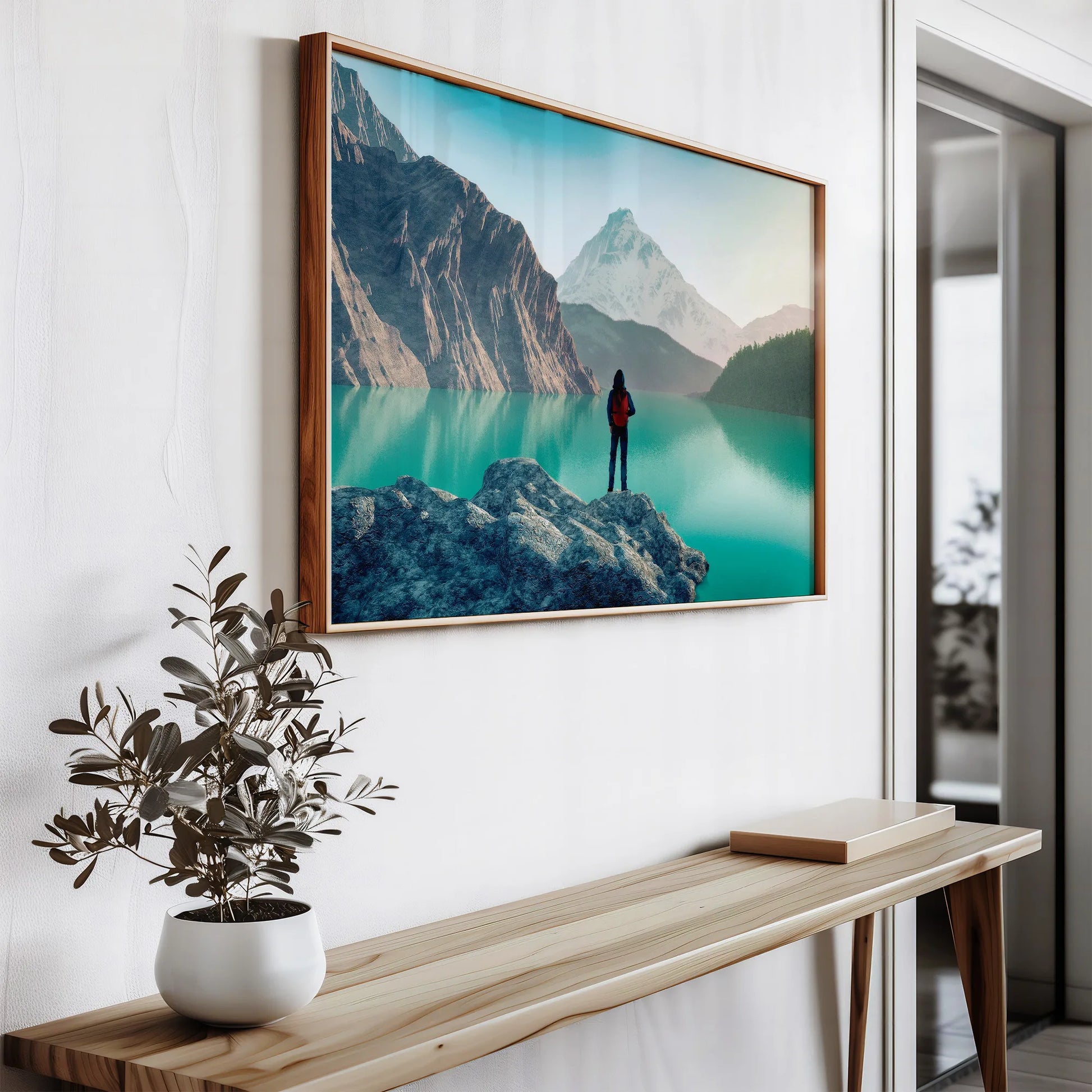 Large format landscape photography print in wooden frame, showing mountainous scenery with vibrant turquoise waters, styled with modern indoor plant decor for Irish living spaces