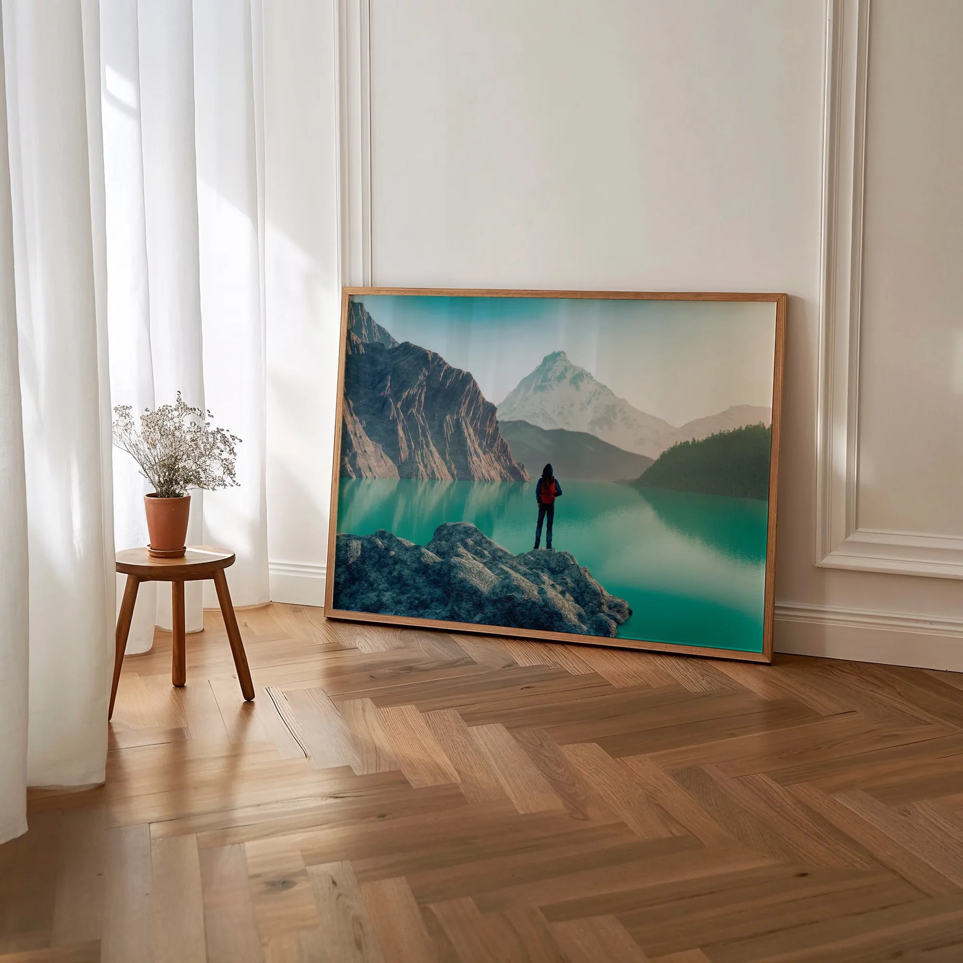 Contemporary mountain vista wall art print above white sofa, featuring scenic lake view and hiker silhouette, ideal for modern Irish home interior design
