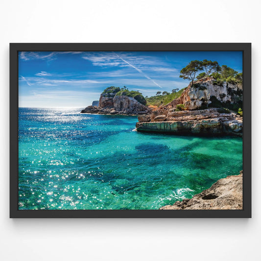 A breathtaking Mediterranean coastal print featuring turquoise waters, rugged cliffs, and lush greenery under a bright blue sky. Sunlight reflects off the crystal-clear sea, creating a vibrant and refreshing scene.