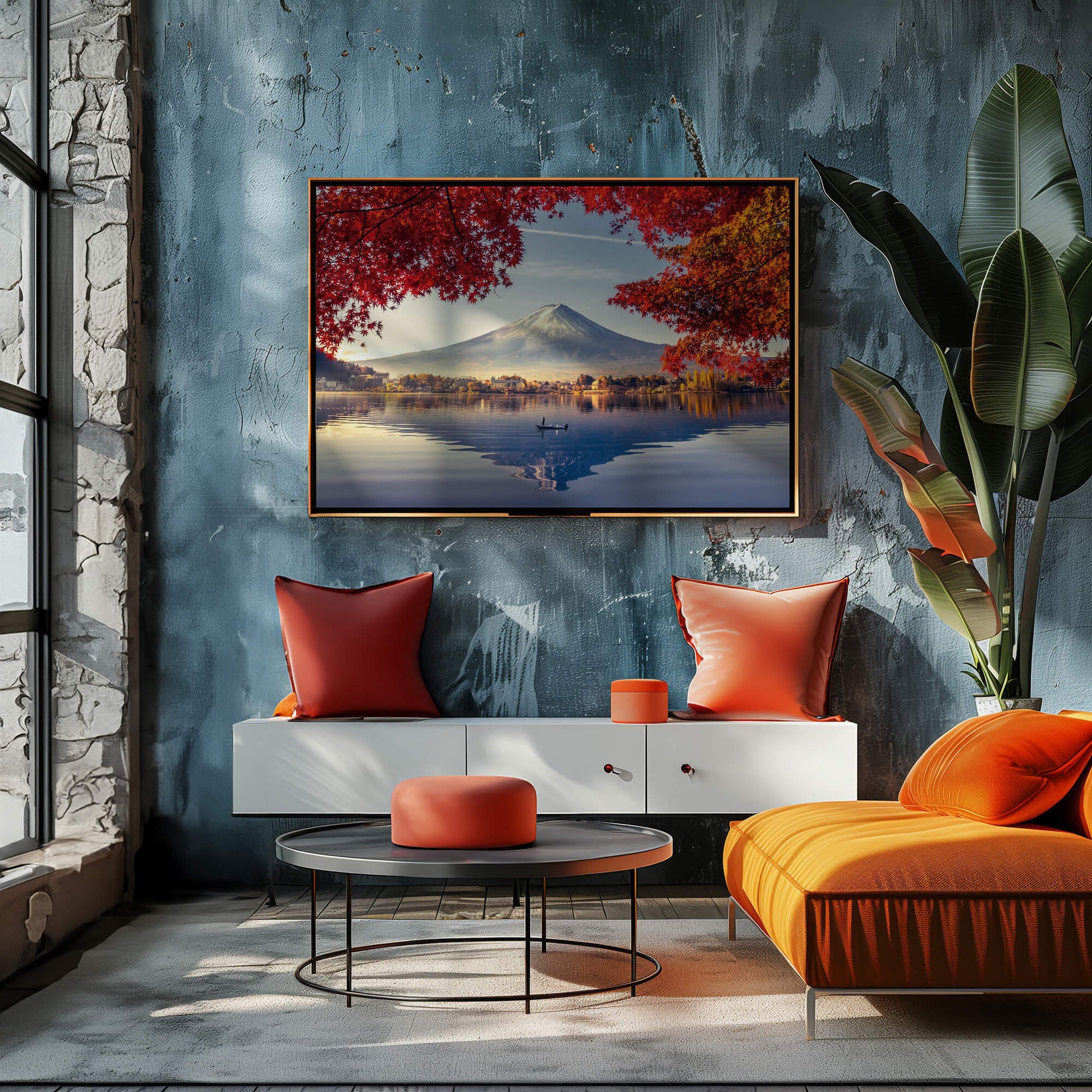 A bold, framed Autumn Fuji print hanging in a stylish, contemporary interior with deep blue walls and warm orange accents.