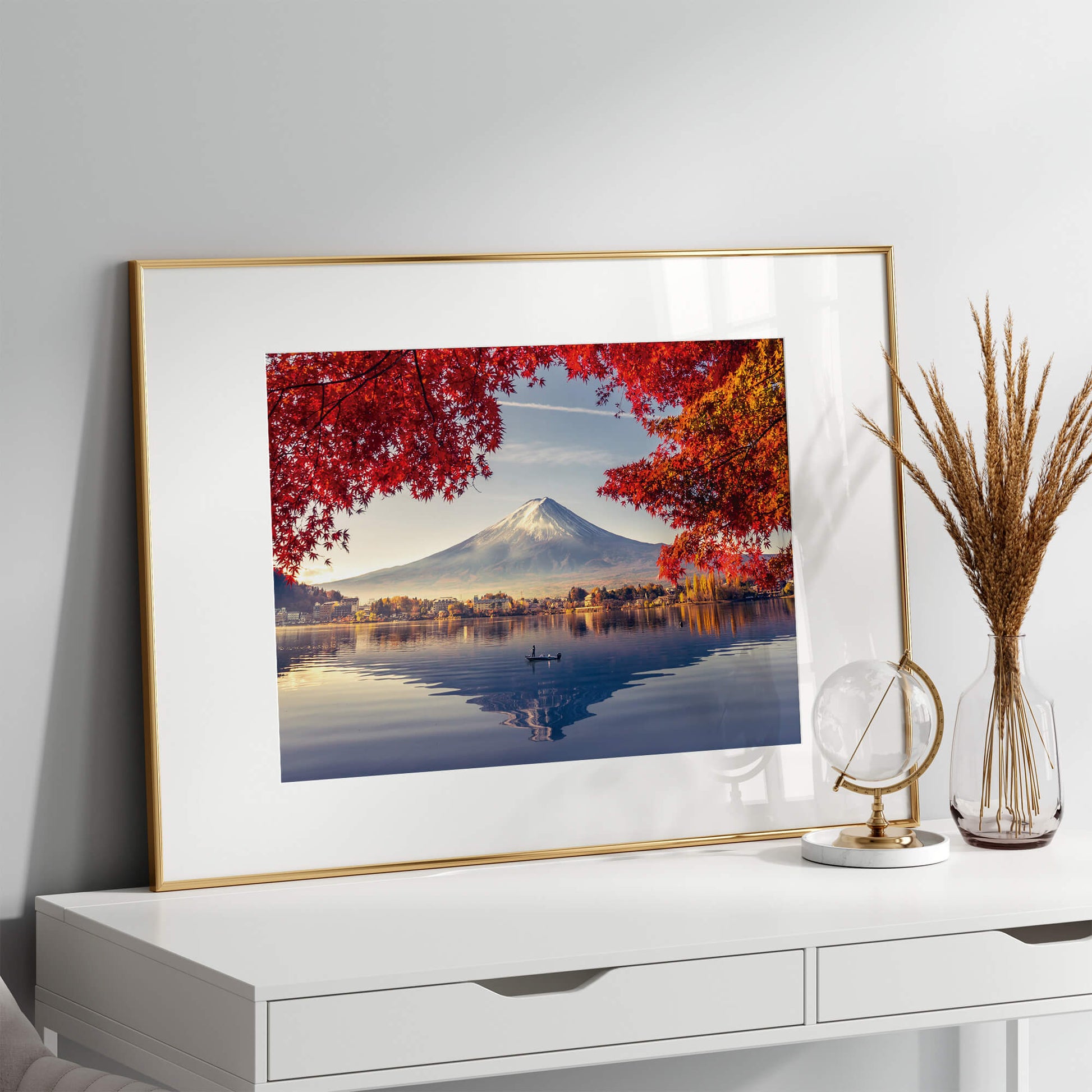 The artwork placed on a desk, leaning against a neutral-toned wall, adding a touch of natural beauty to the space.