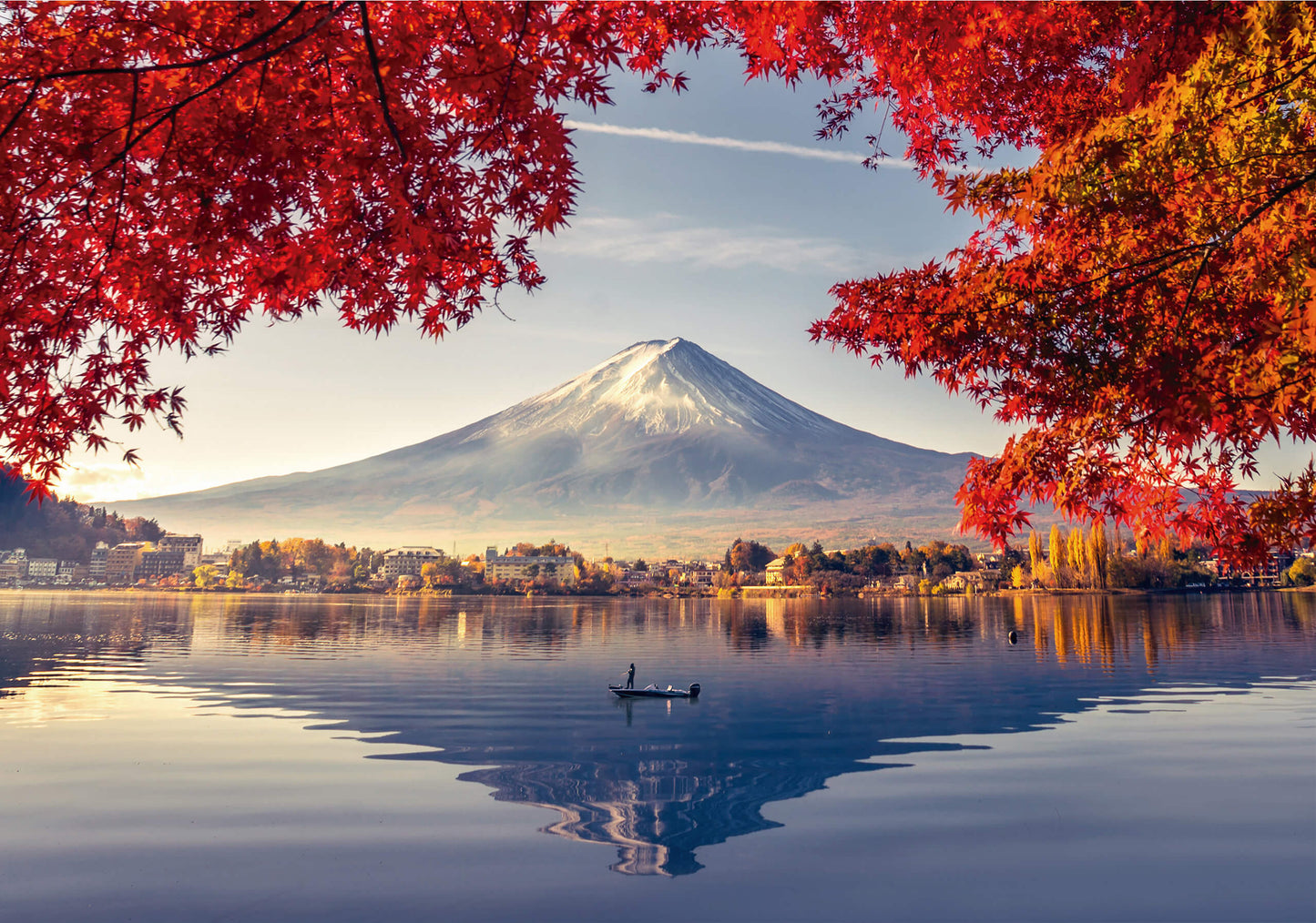 A breathtaking view of Mount Fuji framed by vibrant autumn maple leaves, reflecting in a tranquil lake. A lone boat drifts across the water, adding to the peaceful atmosphere.