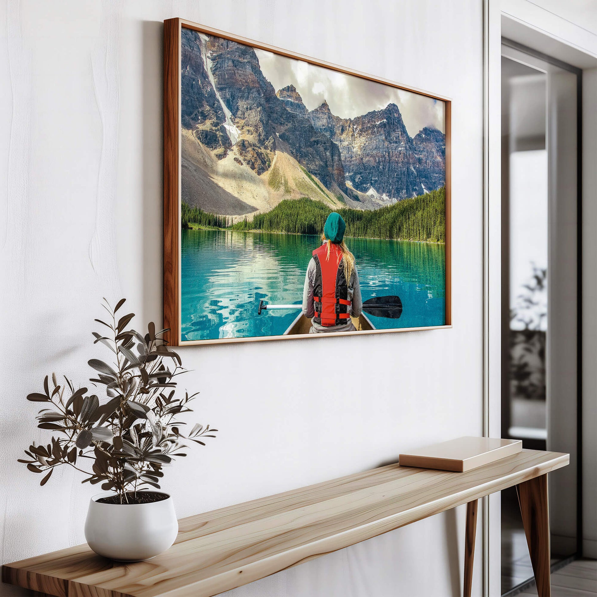 The Mountain Canoeing Print hanging above a console table, adding a nature-inspired touch.