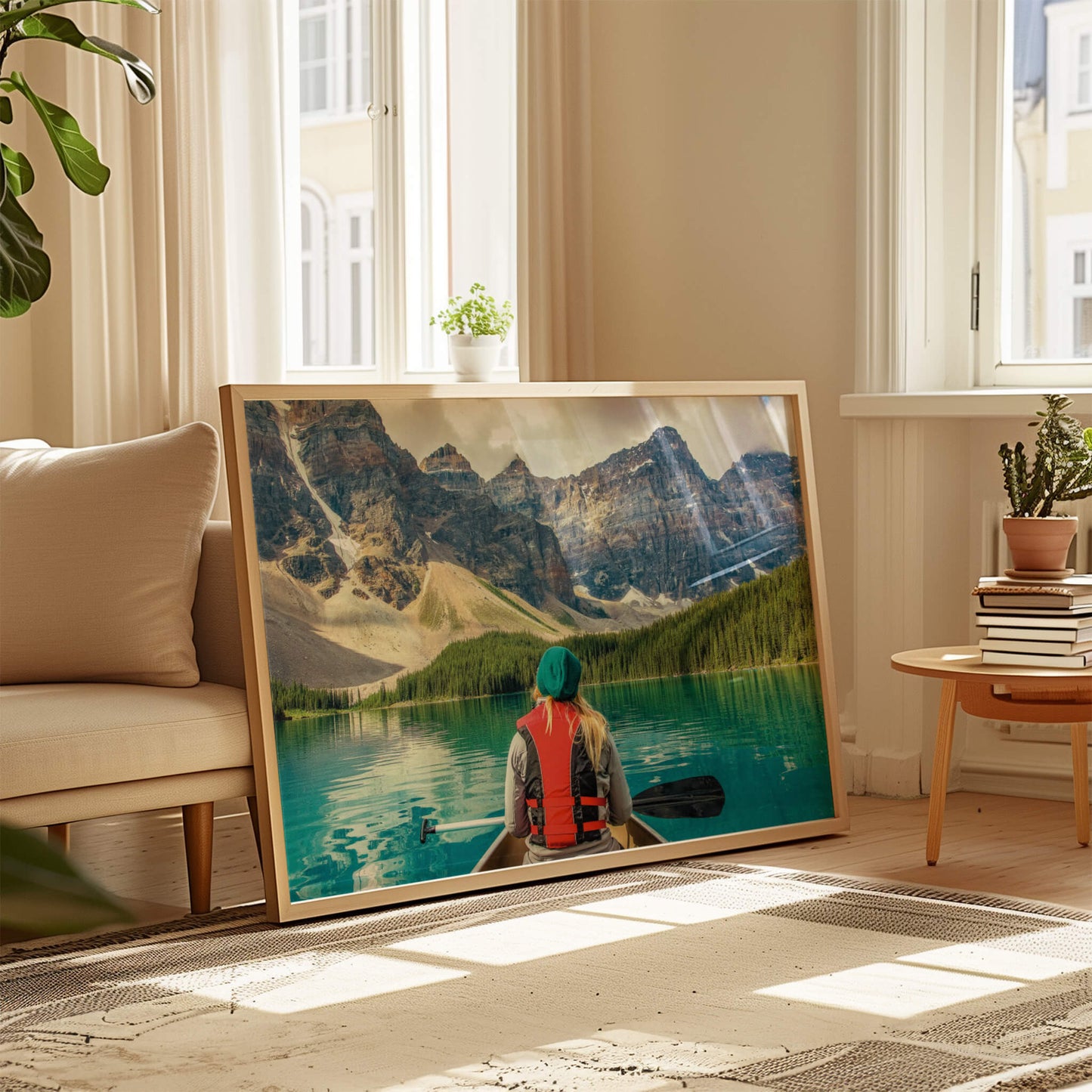 A wooden-framed Mountain Canoeing Print leaning against a wall, surrounded by soft natural light.