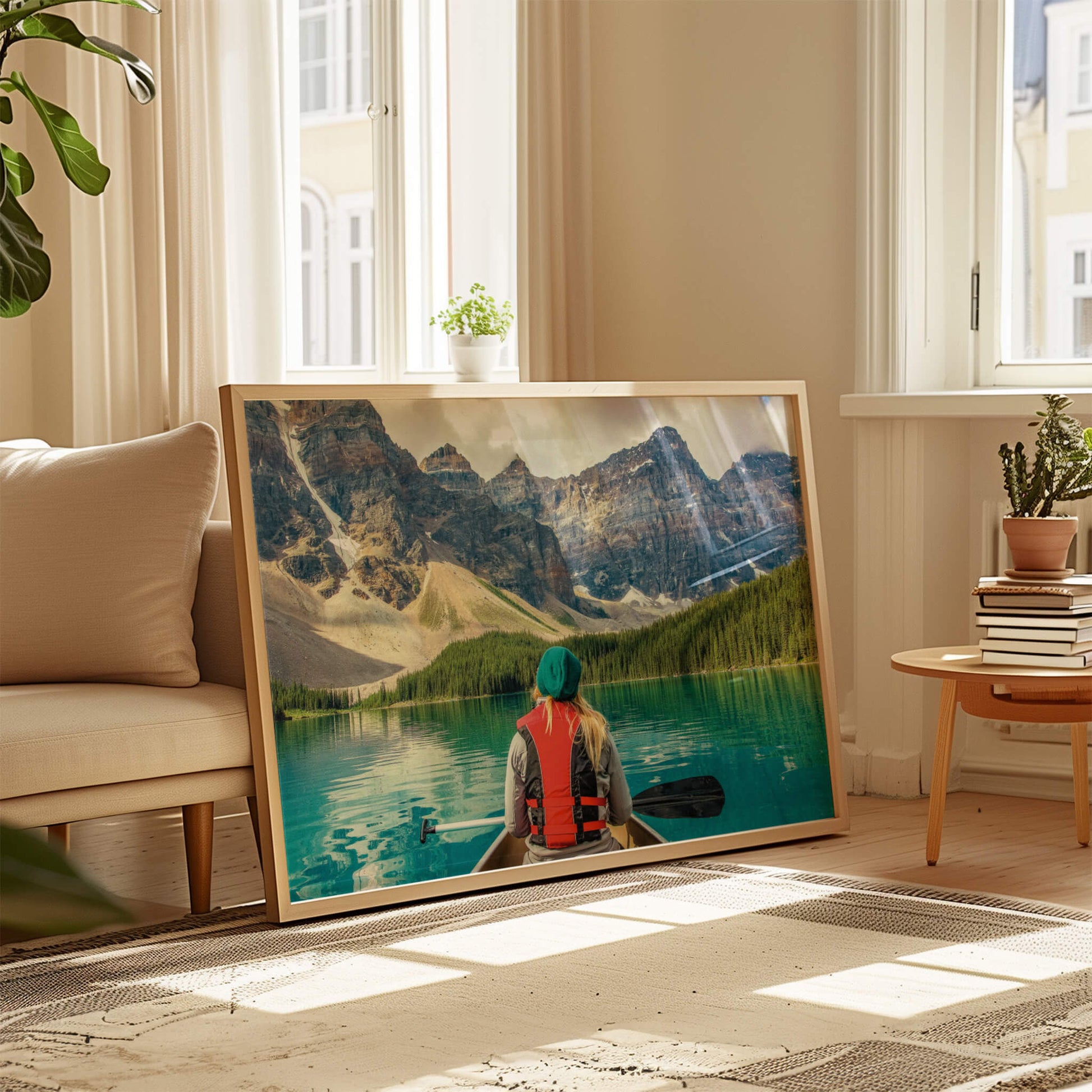 A wooden-framed Mountain Canoeing Print leaning against a wall, surrounded by soft natural light.