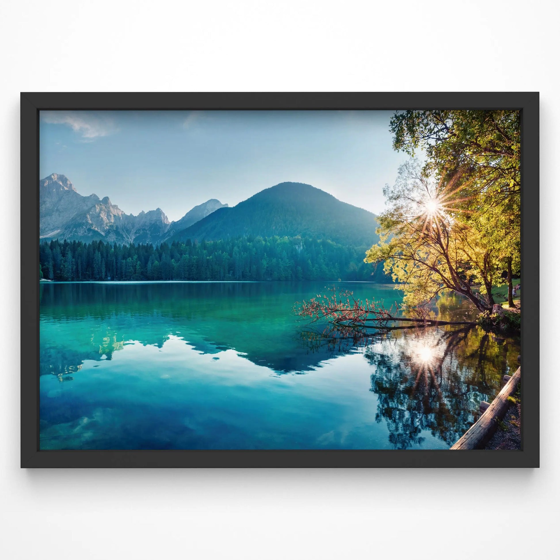 A breathtaking lake landscape print featuring clear turquoise waters, lush forest, and mountain peaks in the background.