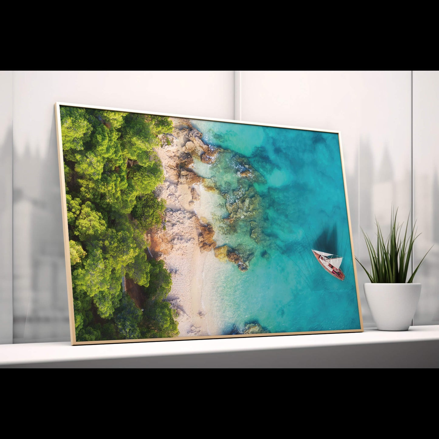 A stylish setting with the Tropical Coastline Print leaning against a white wall on a shelf, ready for display.