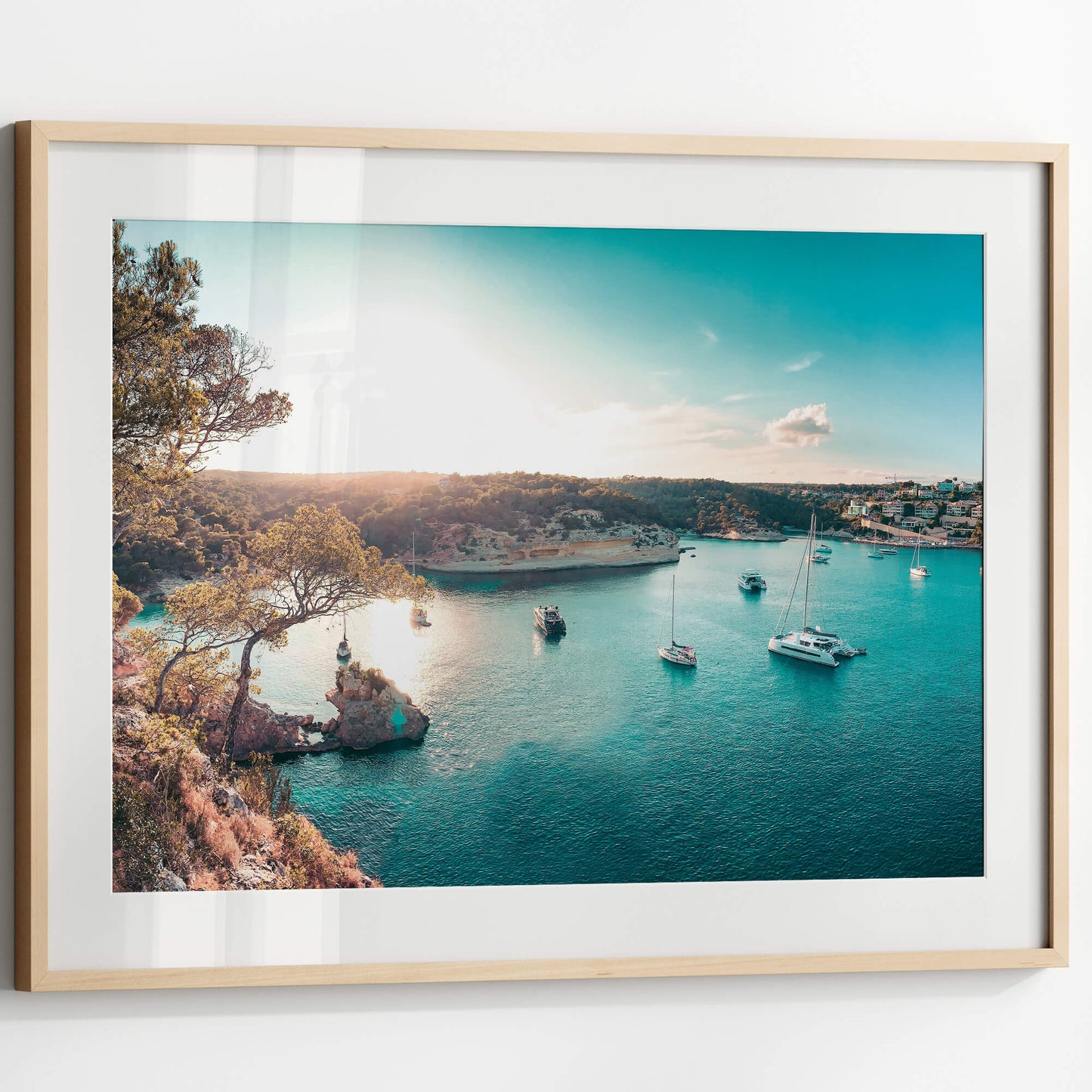 A close-up of the Yacht Bay Print framed in a minimalist wooden border, showcasing the rich blue and gold hues of the seascape.