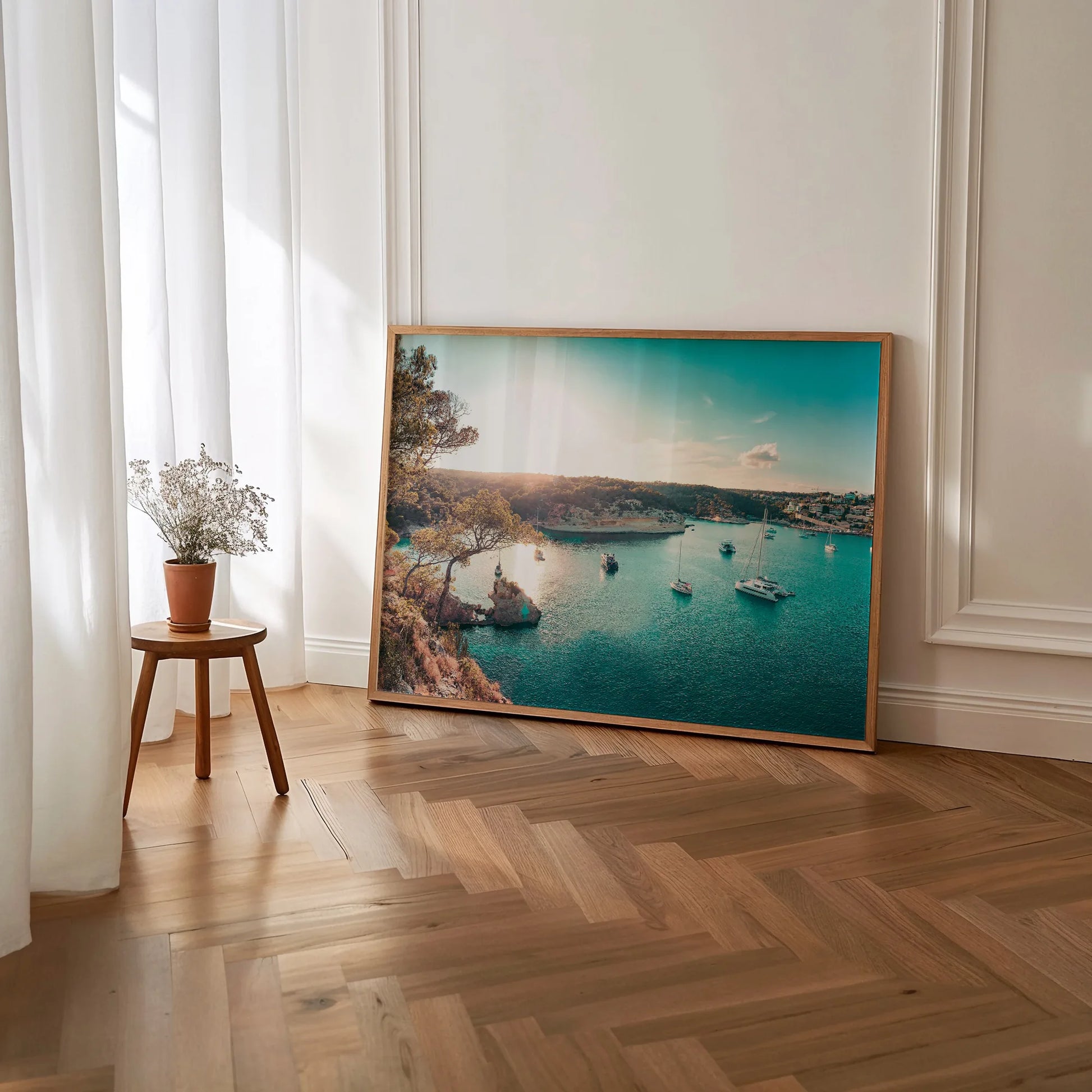 A close-up of the Yacht Bay Print framed in a minimalist wooden border, showcasing the rich blue and gold hues of the seascape.