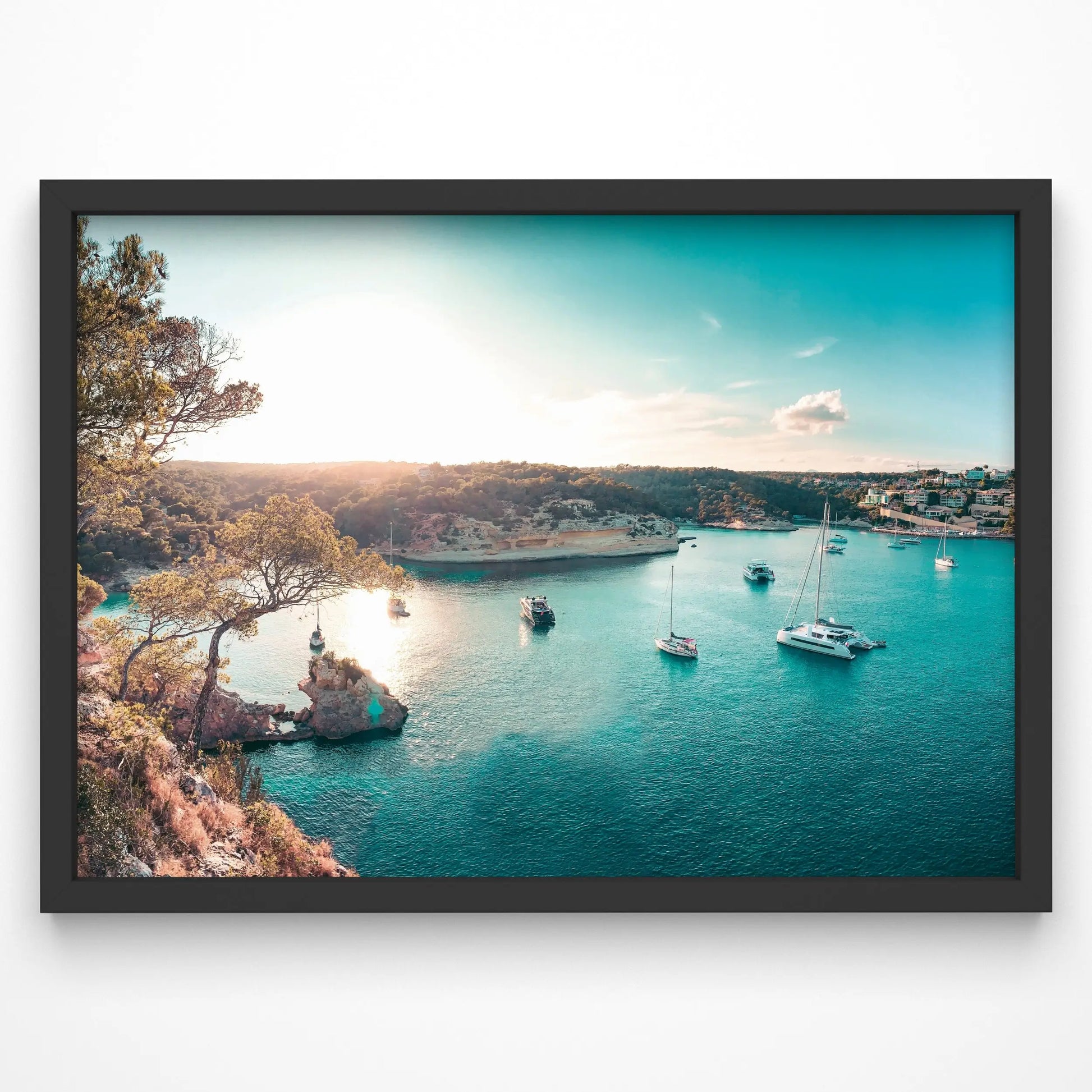 A breathtaking coastal bay scene at sunset with yachts and sailboats floating on turquoise waters. The golden sunlight casts a warm glow over the tranquil cove, surrounded by lush greenery and rocky cliffs.