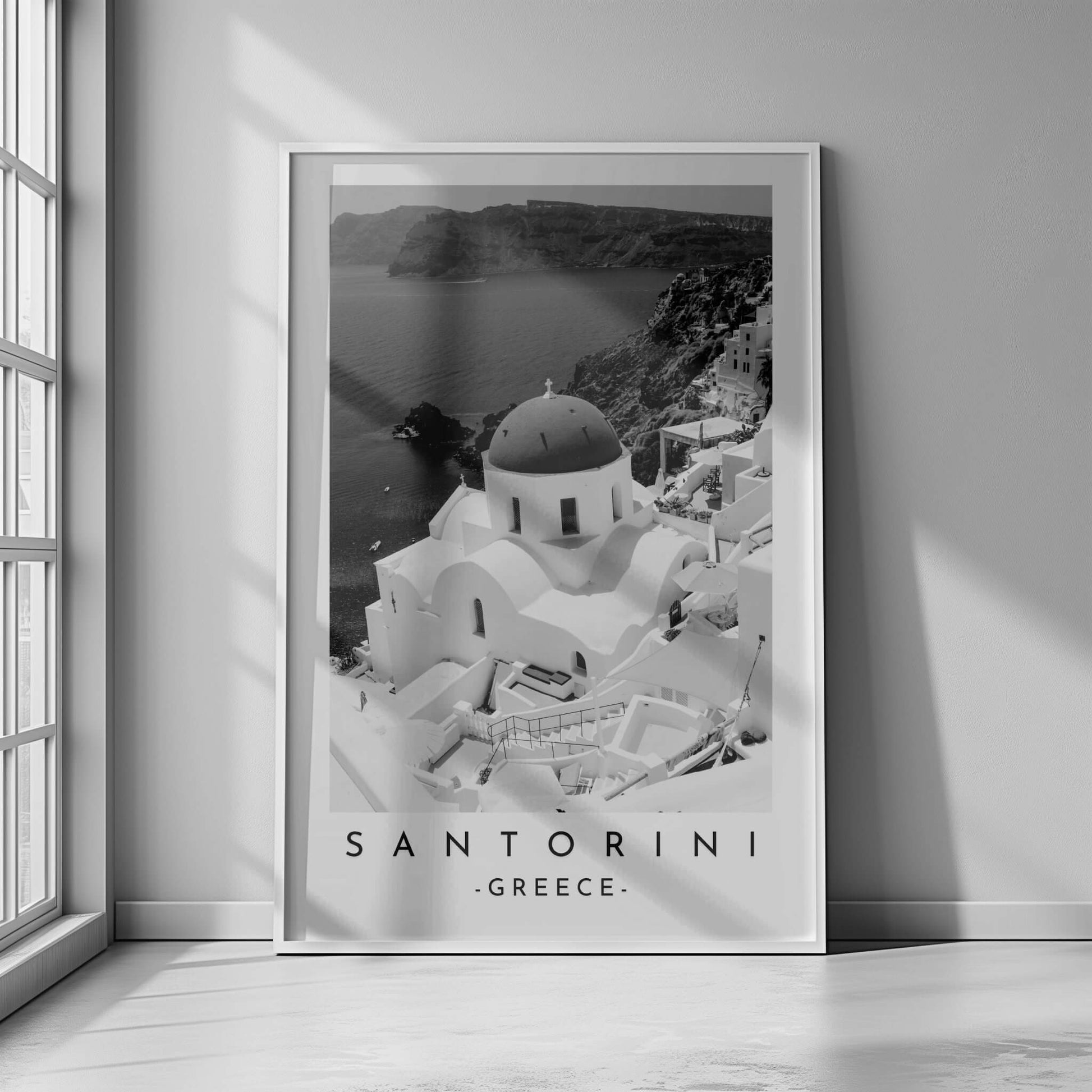 Santorini's iconic church and seascape in a classic black and white photograph, highlighting the island's beauty.
