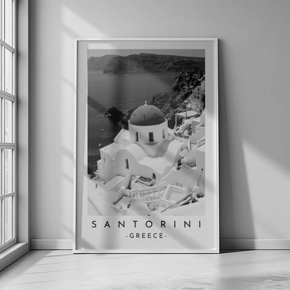 Santorini's iconic church and seascape in a classic black and white photograph, highlighting the island's beauty.
