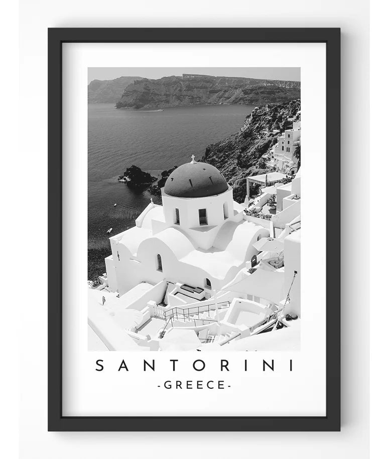 Monochrome photograph of a domed church in Santorini, Greece, overlooking the Aegean Sea.
