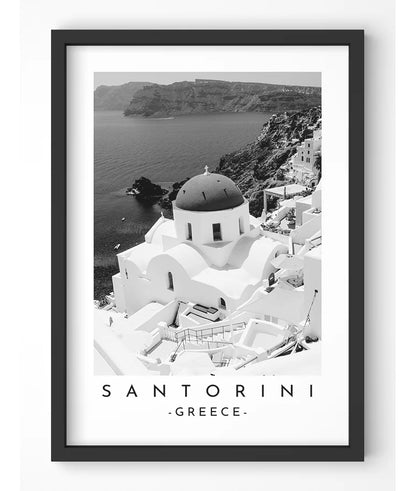 Monochrome photograph of a domed church in Santorini, Greece, overlooking the Aegean Sea.
